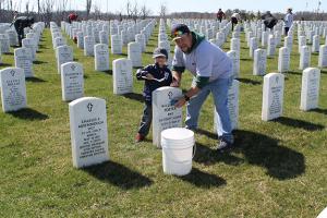 The MCO's Military Members committee cleans veteran's headstones in spring 2016. MCO has many members that volunteer in their communities.