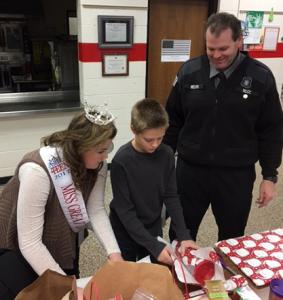 Jackson-area COs helped Blackman Township police with their Shop with a Cop program last year. Shop with a Cop is just one way officers give back to their communities. CO Melvin and his daughter, Izzy Melvin, Ms. Great Lakes Outstanding Teen, helped the kids shop and wrap gifts. Photo by Sheila Melvin.